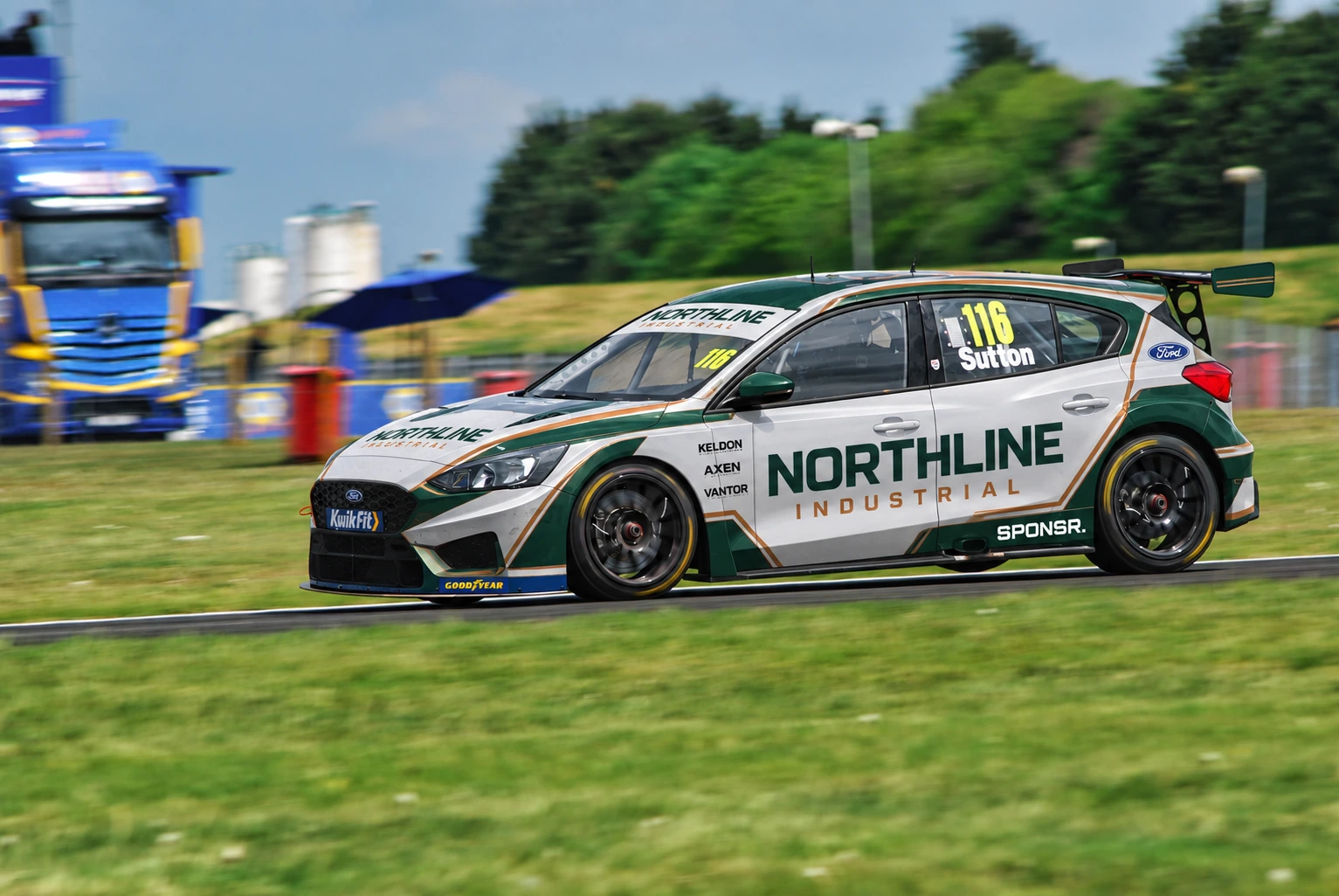 A white and green Ford Focus touring car cornering at Snetterton (SPONSR livery concept).