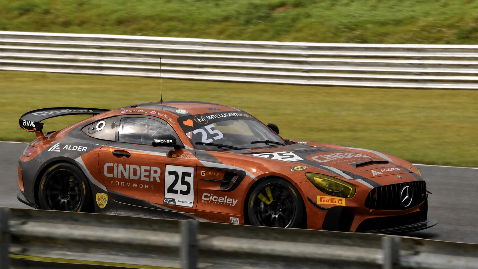 A lone orange Mercedes-AMG GT car at speed past the barriers (SPONSR livery concept).